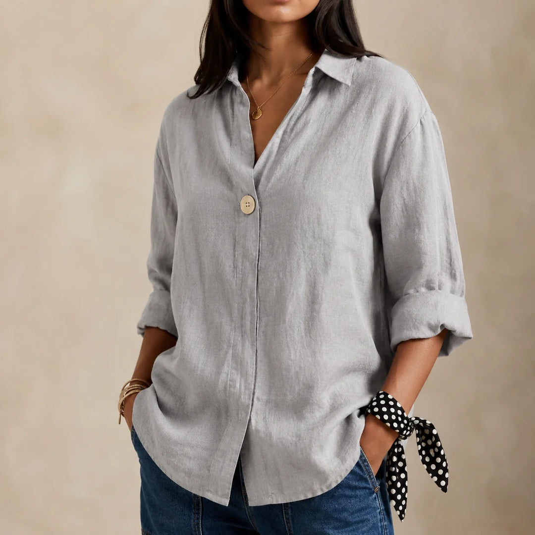Full-length view of relaxed linen blouse highlighting V-neckline and curved hem