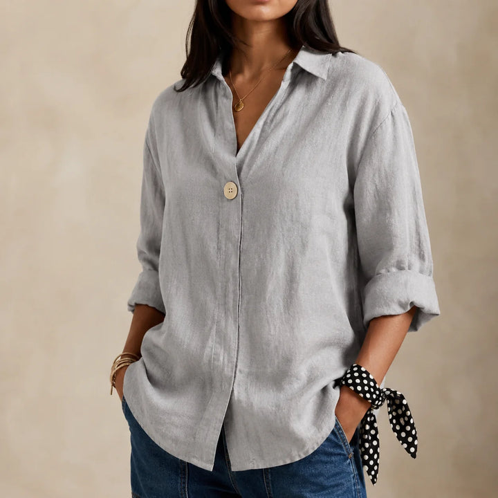 Full-length view of relaxed linen blouse highlighting V-neckline and curved hem