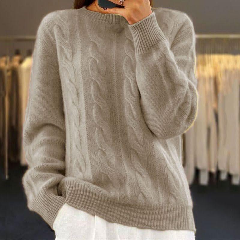 Side view of women's cable knit jumper showing ribbed hem and cuff detail