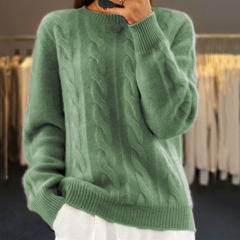 Women's cream cable knit jumper styled with white trousers for casual wear
