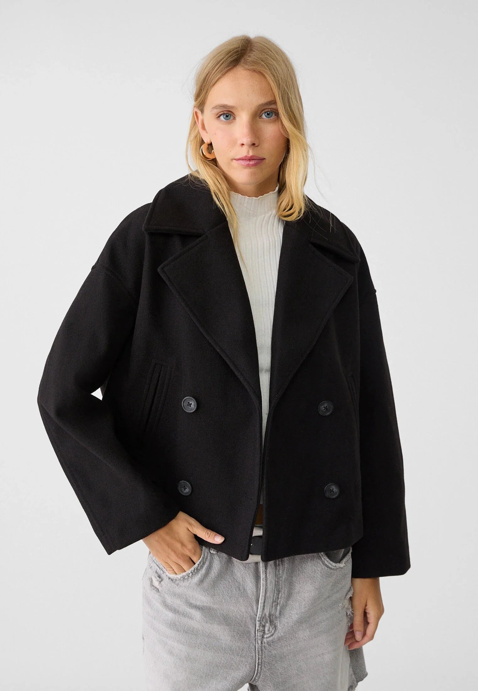 Close-up view of double breasted blazer showing button closure and structured lapel detail