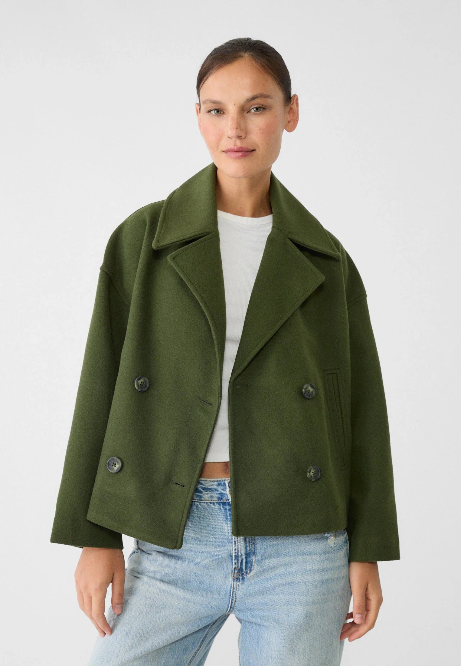 Women's tailored blazer in beige paired with denim shorts for smart-casual styling