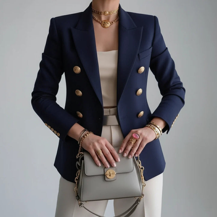 Close-up view of women's tailored blazer showing double-breasted button detailing and flap pockets