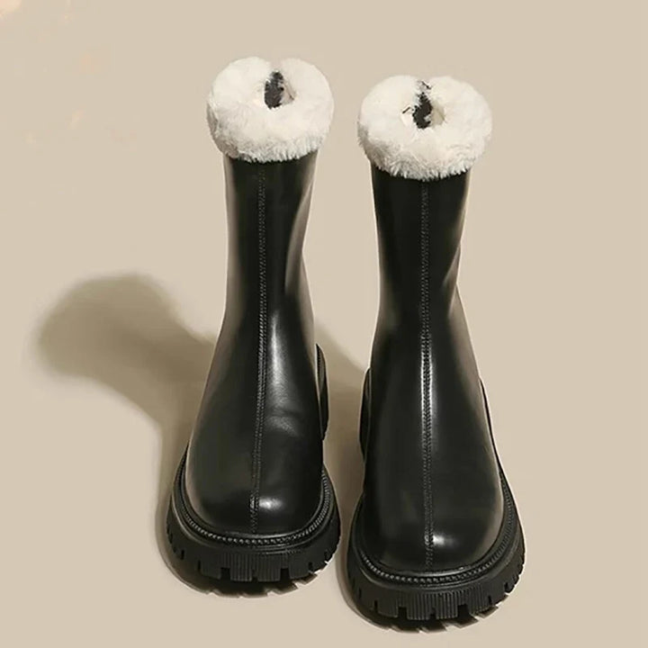 Front view of beige fleece ankle boots showing smooth exterior and front zip closure detail