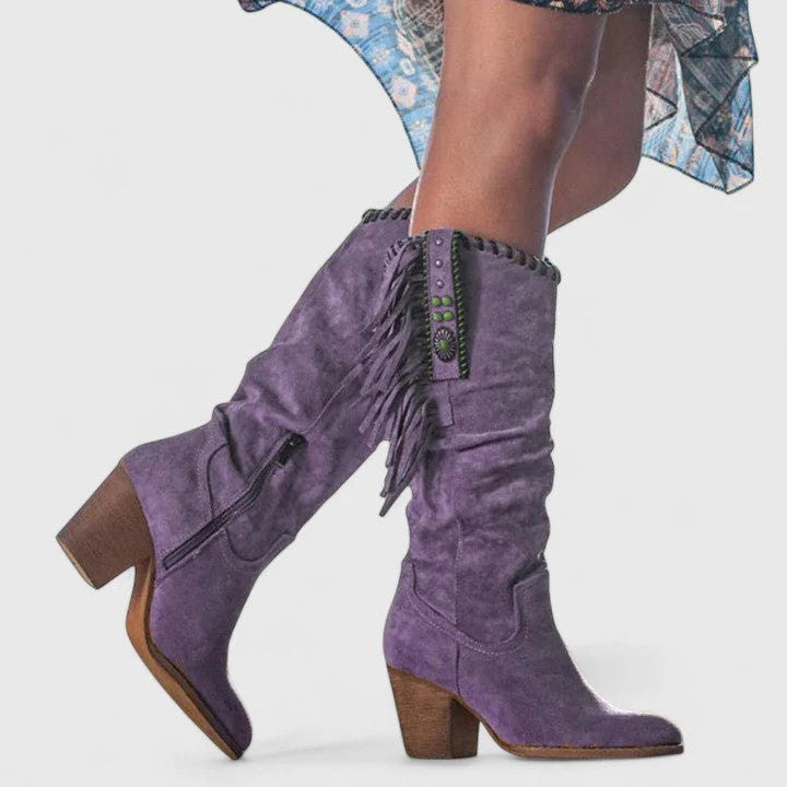 Side view of fringe knee-high boots showing cascading fringe detail and whipstitch trim