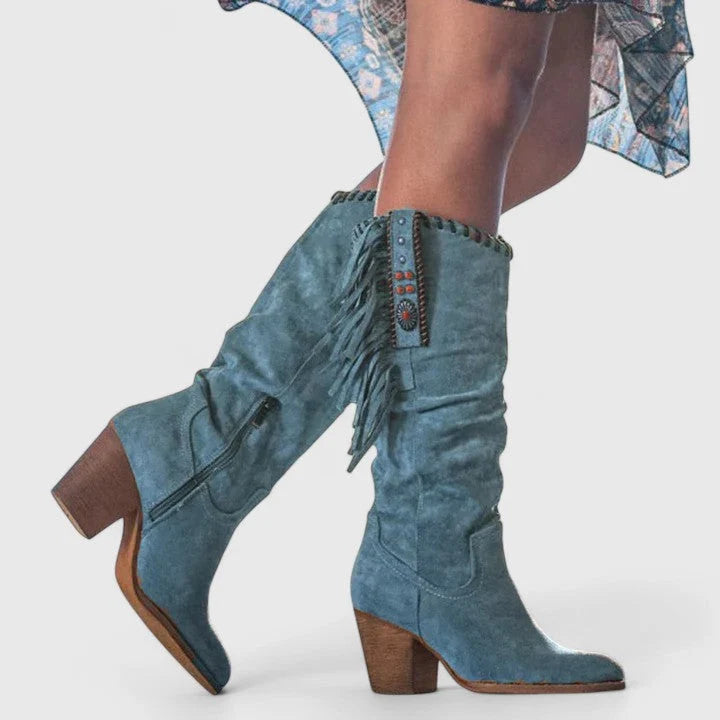 Close-up of block heel and fringe detailing on women's mid-calf boots