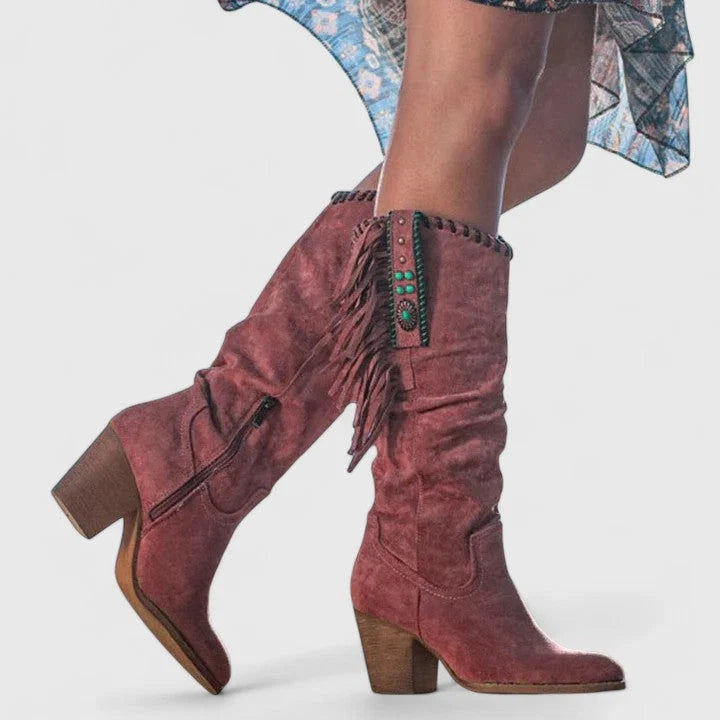 Rear view of knee-high boots with fringe trim and side zip closure