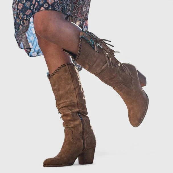 Detail shot of suede-effect upper and decorative whipstitch edging on fringe boots