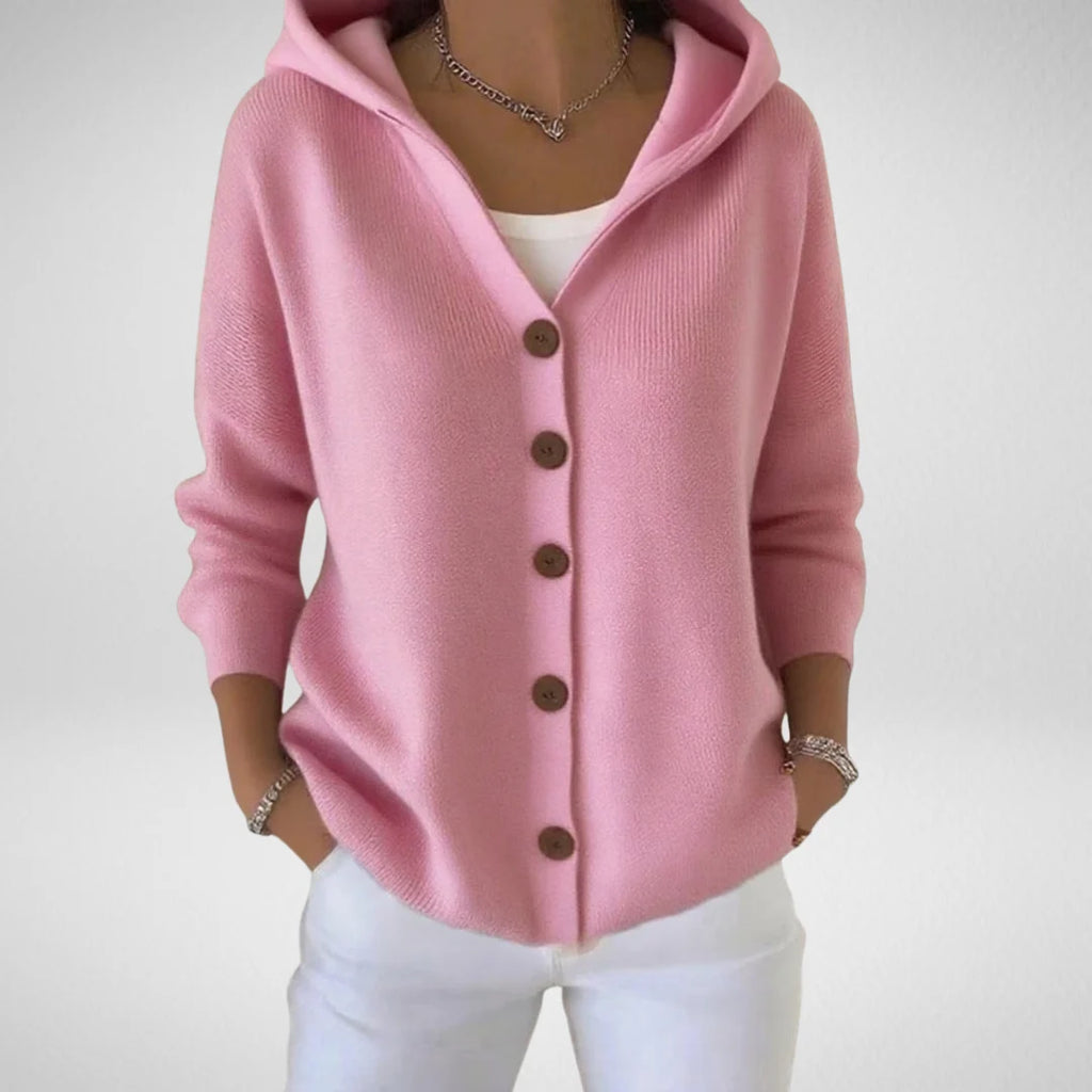 Women's hooded cardigan in pink with button-front closure and relaxed fit worn over white top