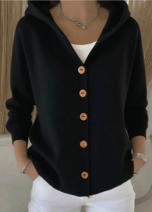 Women's hooded cardigan layered over white top demonstrating versatile styling