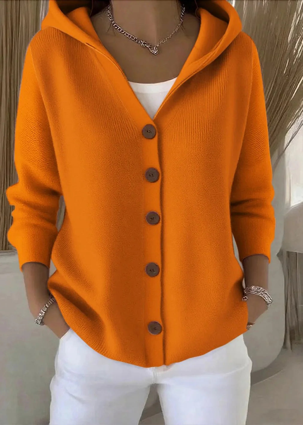 Detail shot of cardigan hood and neckline with button closure