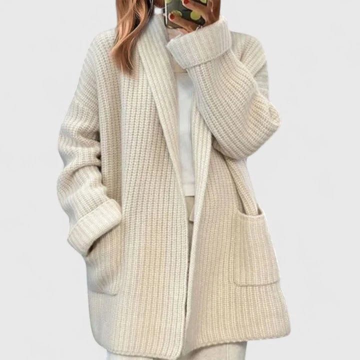 Rear view of oversized cardigan showing dropped shoulder seam and relaxed drape of ribbed knit fabric