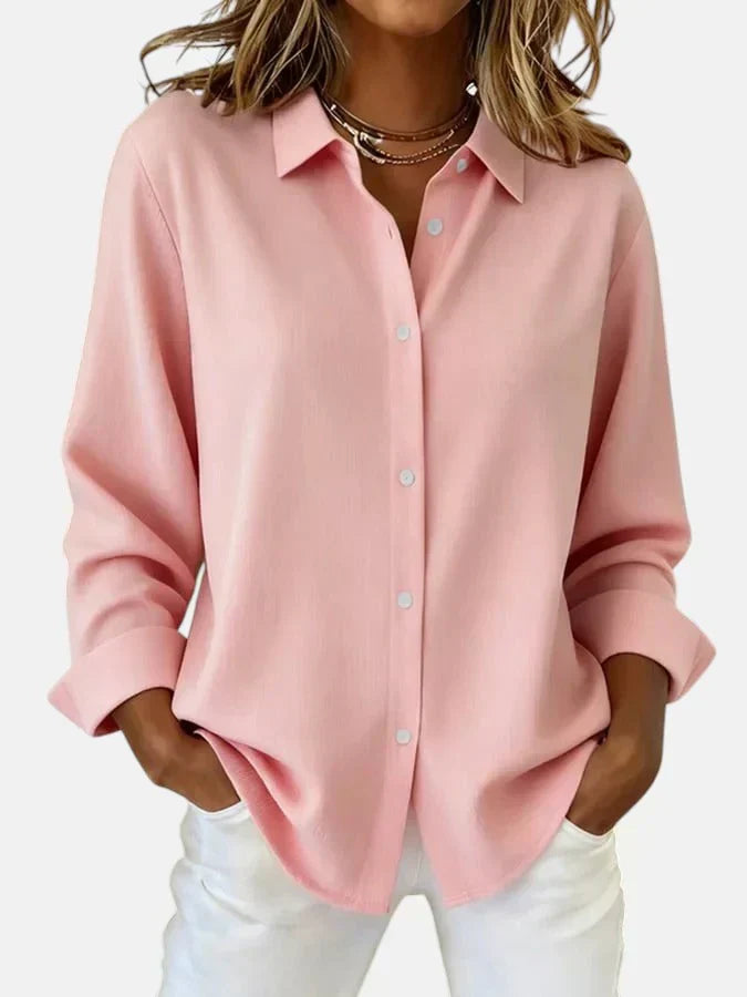 Close-up view of oversized shirt showing smooth woven fabric, dropped shoulders, and relaxed fit silhouette