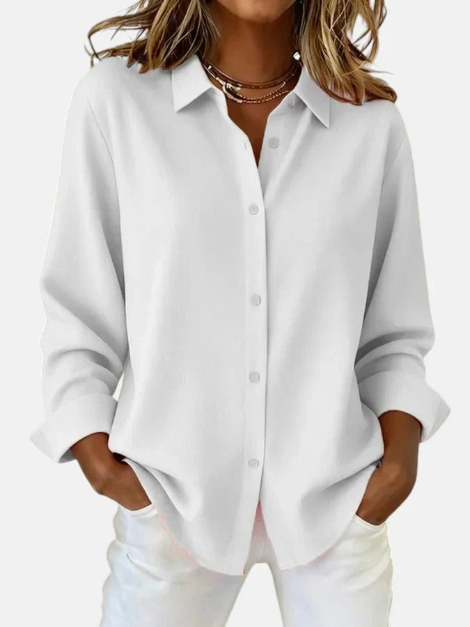 Detail shot of oversized shirt's button-front placket and collar construction in smooth woven fabric