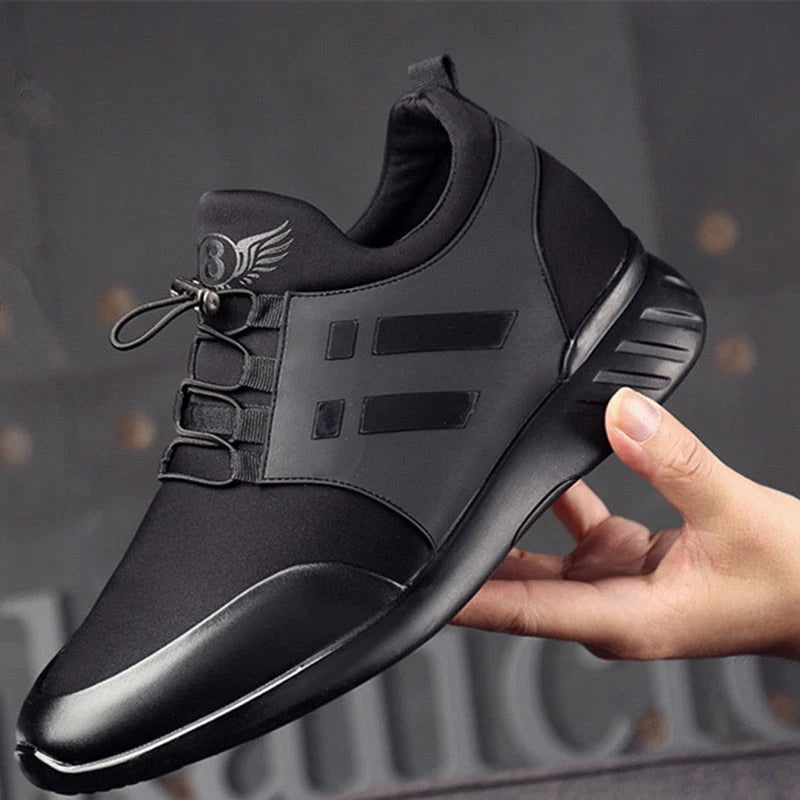 Side profile of men's supportive trainers with cushioned sole and wide toe box construction