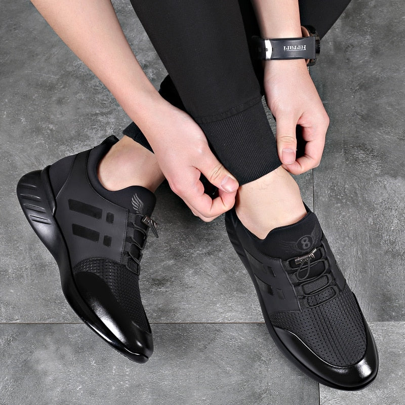 Men's black trainers worn with joggers showing low-profile silhouette and casual styling