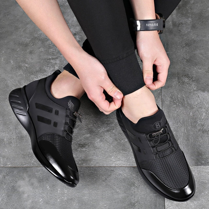 Men's black trainers worn with joggers showing low-profile silhouette and casual styling