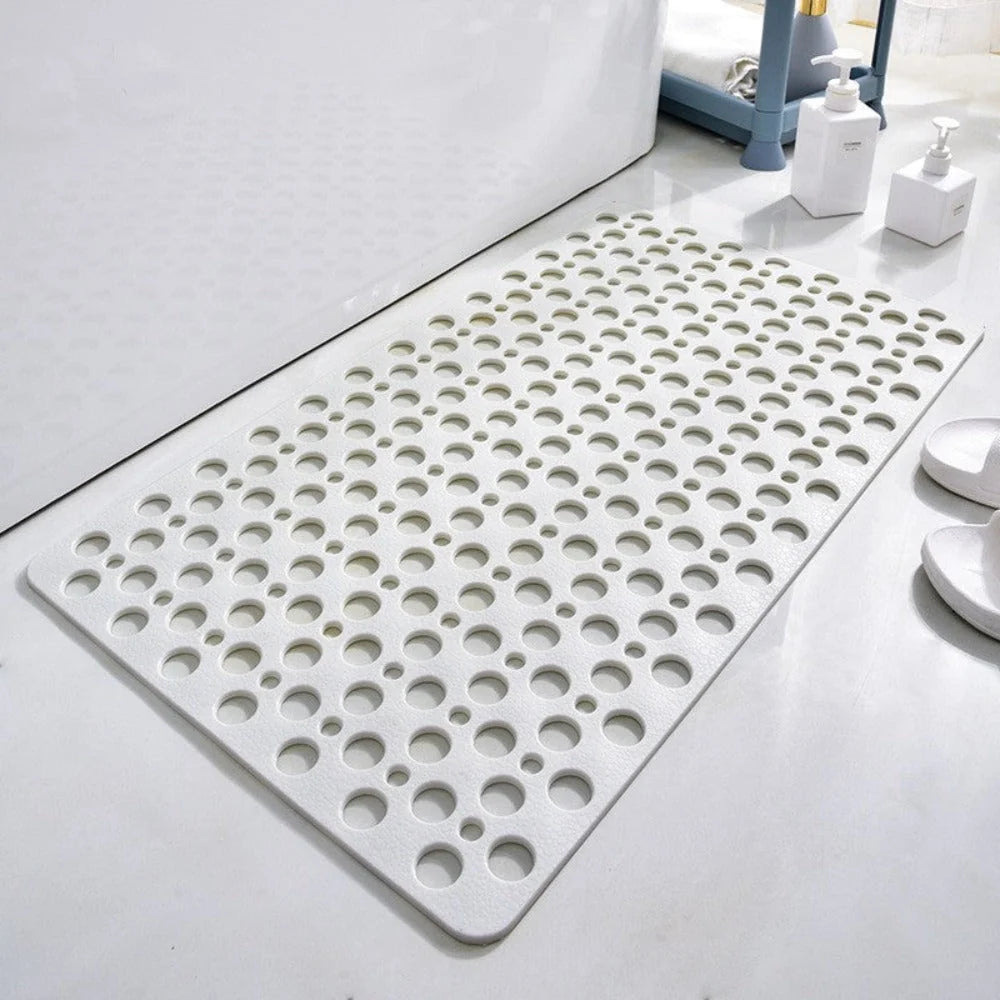 Bathroom safety mat in blue placed beside shower with toiletries visible