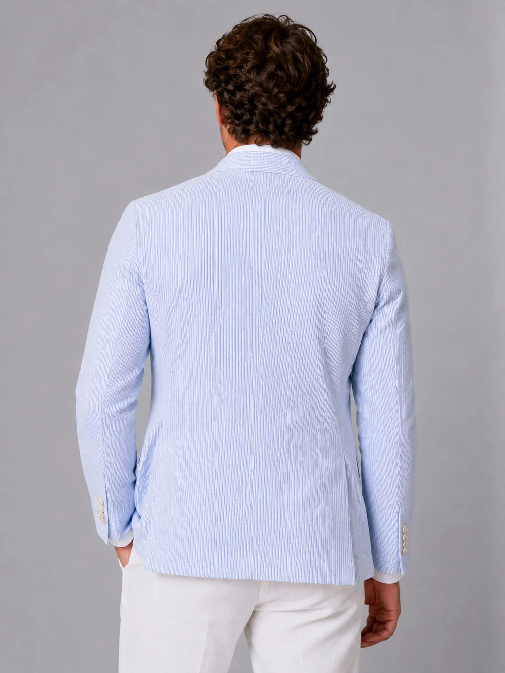 Side angle of men's striped seersucker blazer showing relaxed fit
