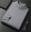 Men's grey turtleneck jumper with ribbed collar and cuffs, folded presentation