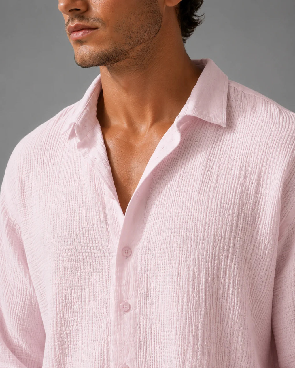 Close-up view of men's linen shirt showing lightweight crinkle fabric and button-through front