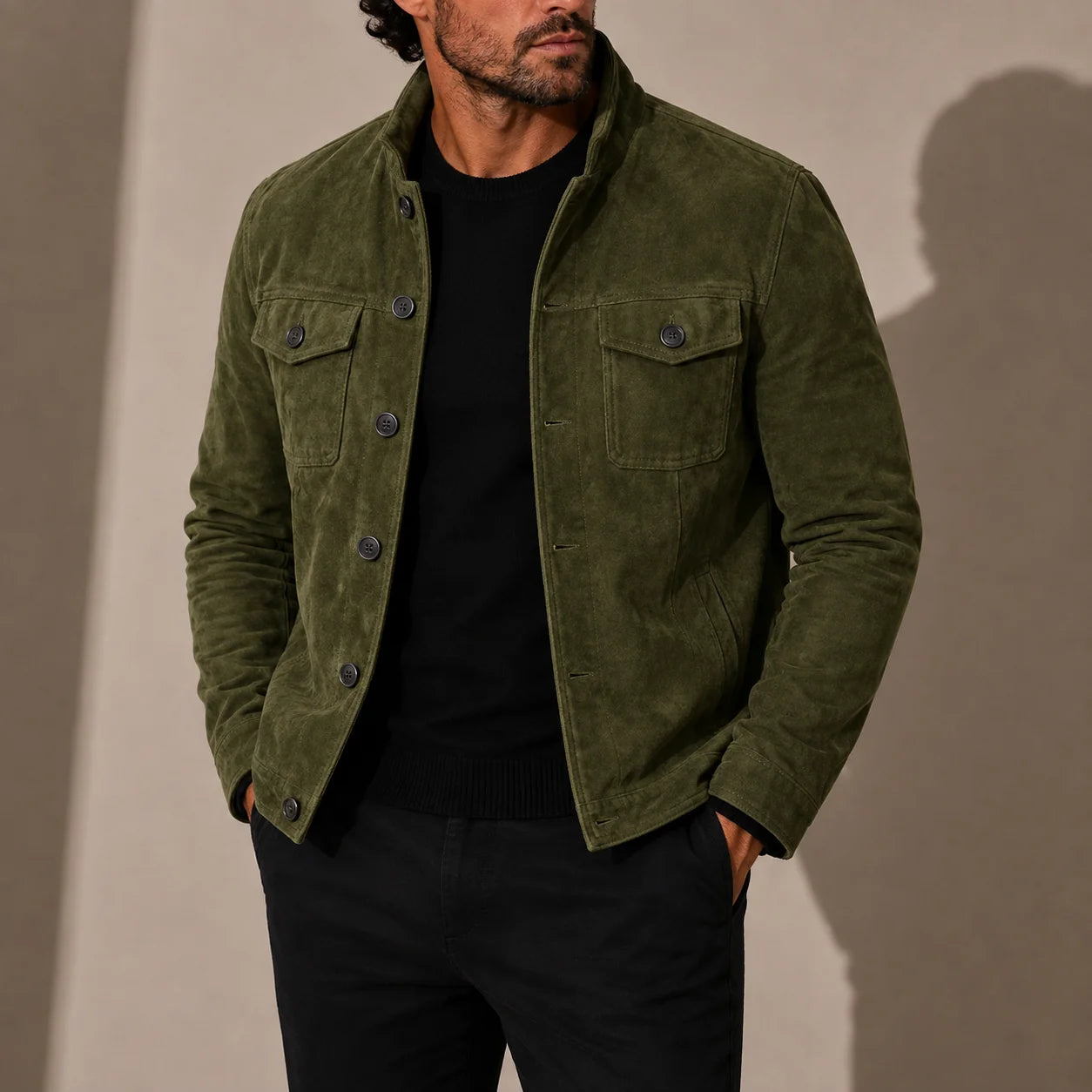 Close-up view of men's brown suede jacket showing stand collar, chest pockets and button closure detail