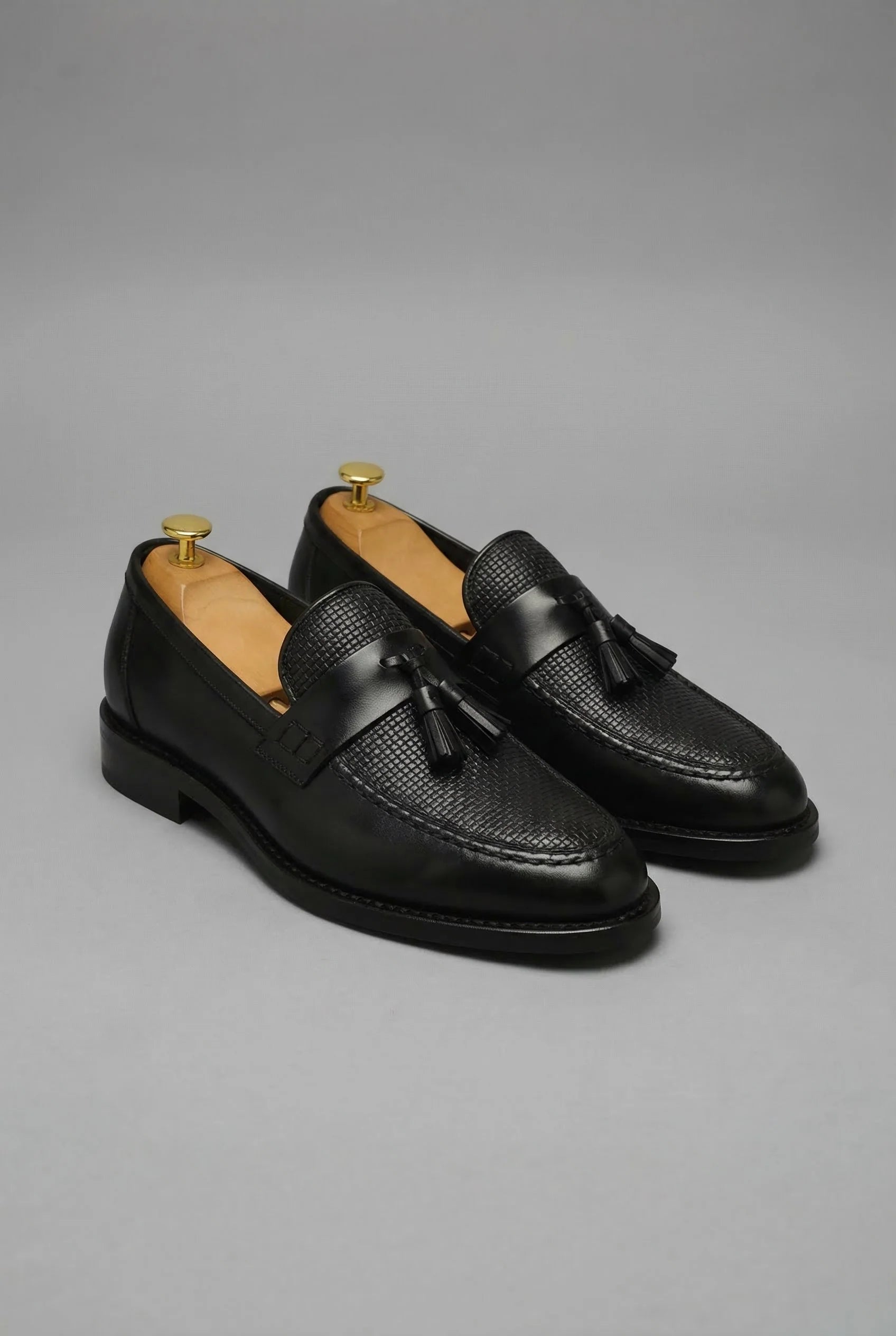 Rear view of men's black loafers with structured heel and cushioned sole construction