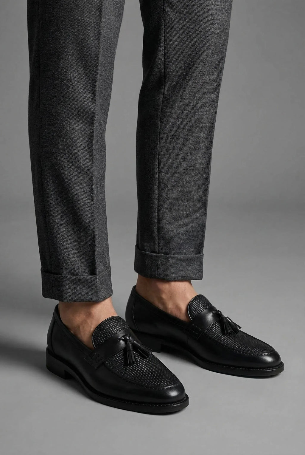 Top-down view of men's woven tassel loafers showing slip-on opening and footbed design