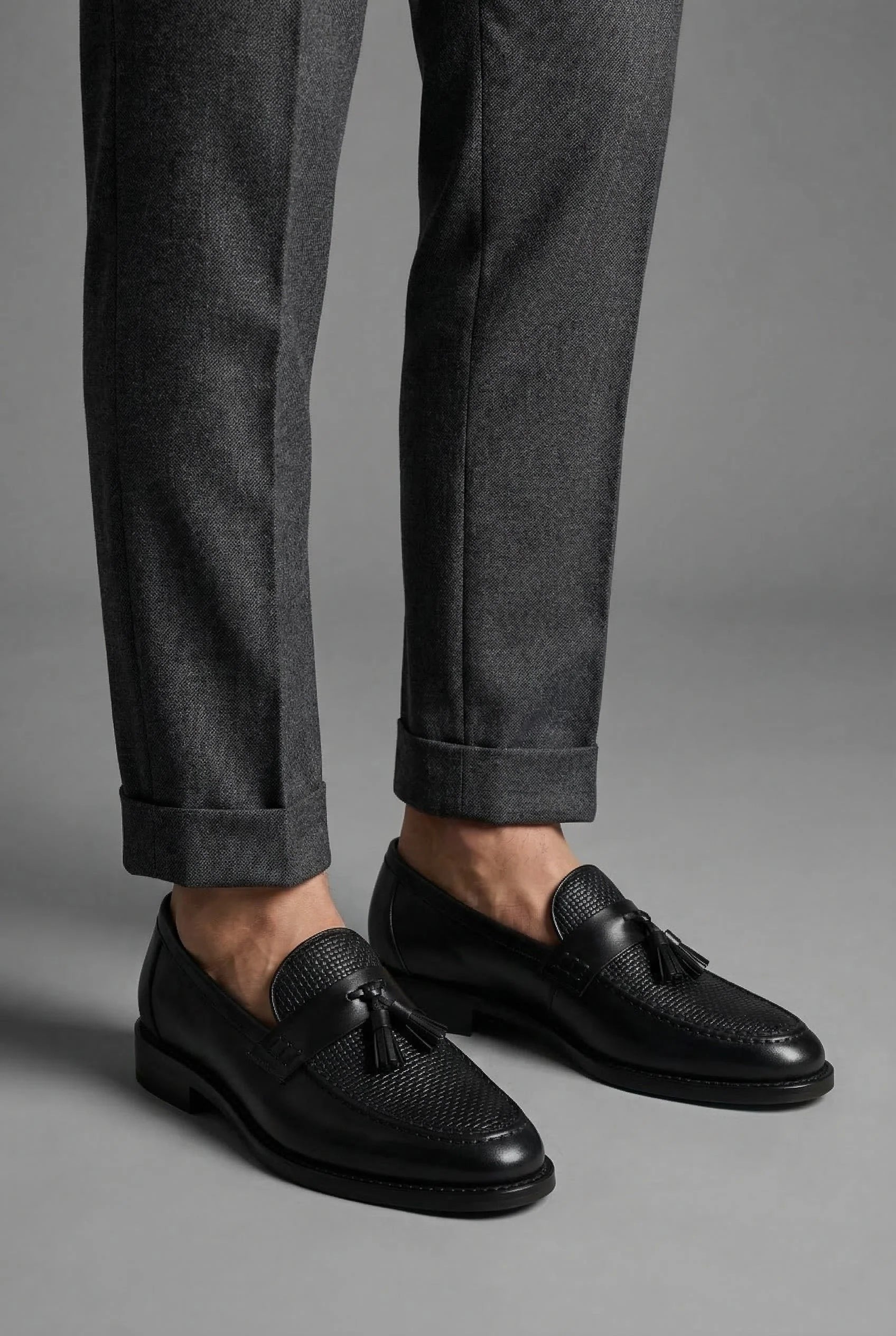 Top-down view of men's woven tassel loafers showing slip-on opening and footbed design