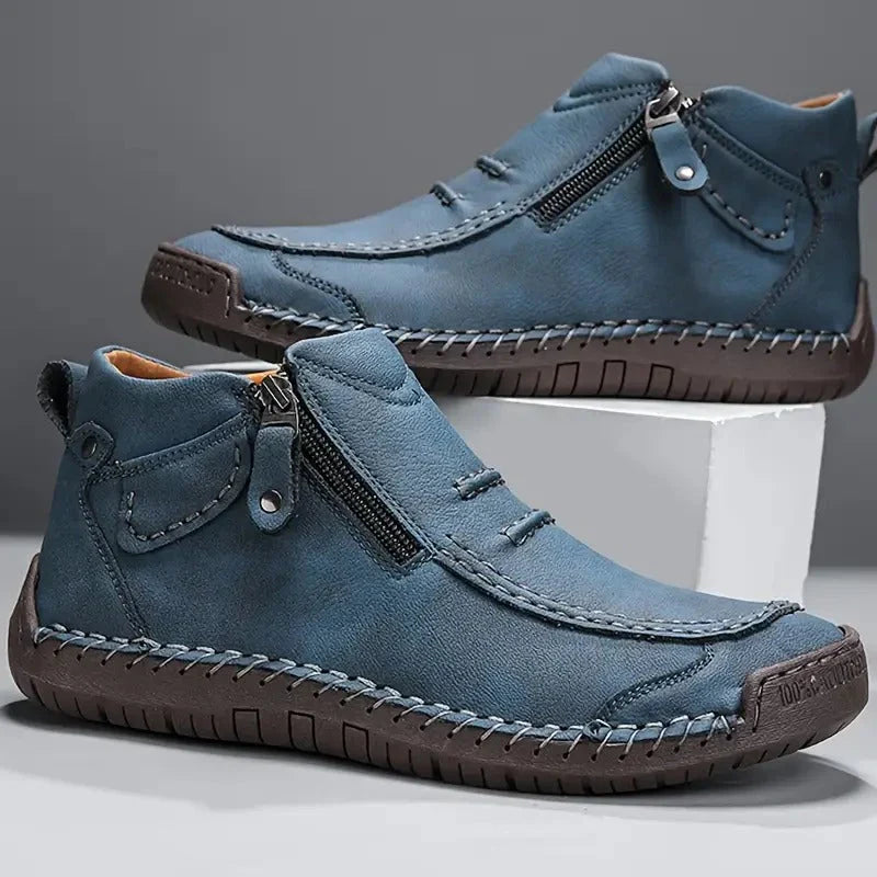 Close-up view of men's ankle boots showing stitched detailing and reinforced toe cap