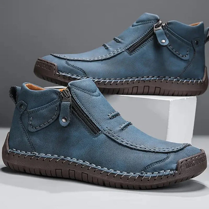 Close-up view of men's ankle boots showing stitched detailing and reinforced toe cap