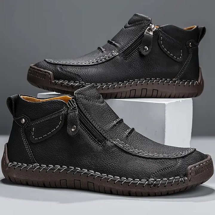Side profile of men's ankle boots with side zip fastening and structured upper