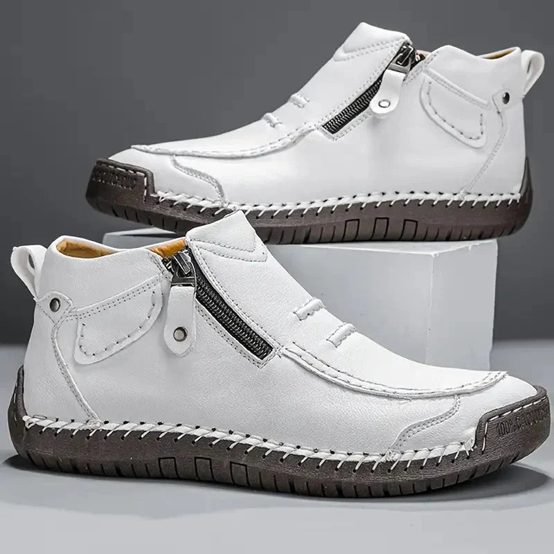 Men's ankle boots displayed on white surface highlighting lugged sole and brown finish