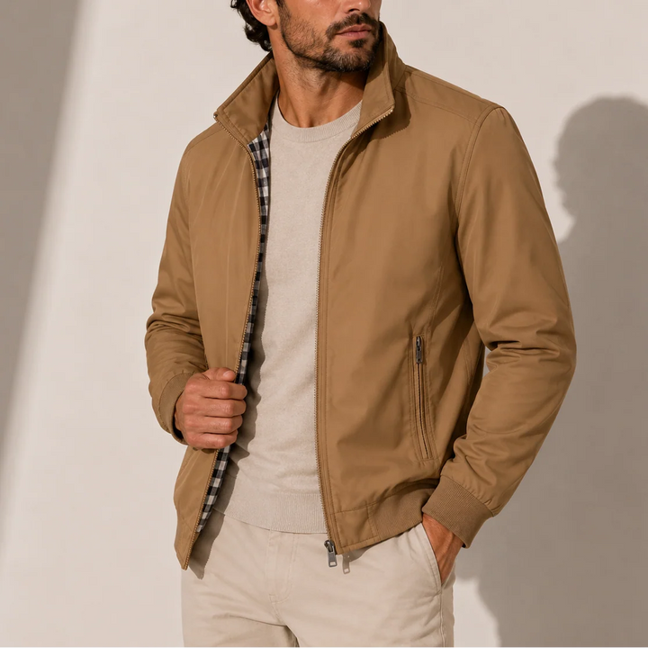 Close-up of men's bomber jacket showing stand collar, zip detail and checked inner lining