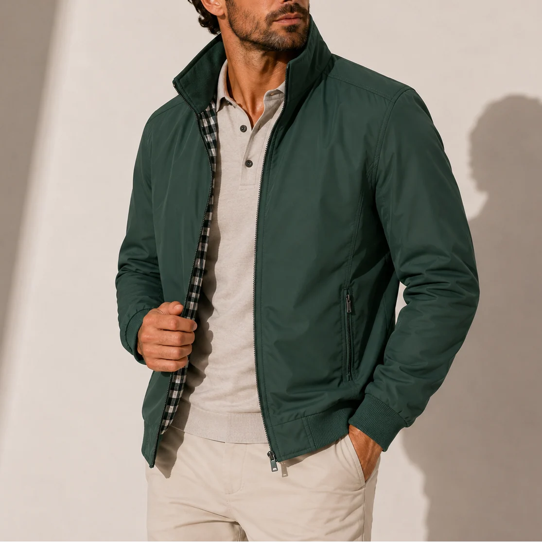 Side view of lightweight men's bomber jacket with zippered pocket and ribbed cuffs
