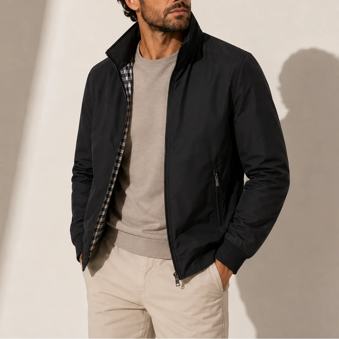 Men's bomber jacket styled with beige chinos and polo shirt for smart-casual look