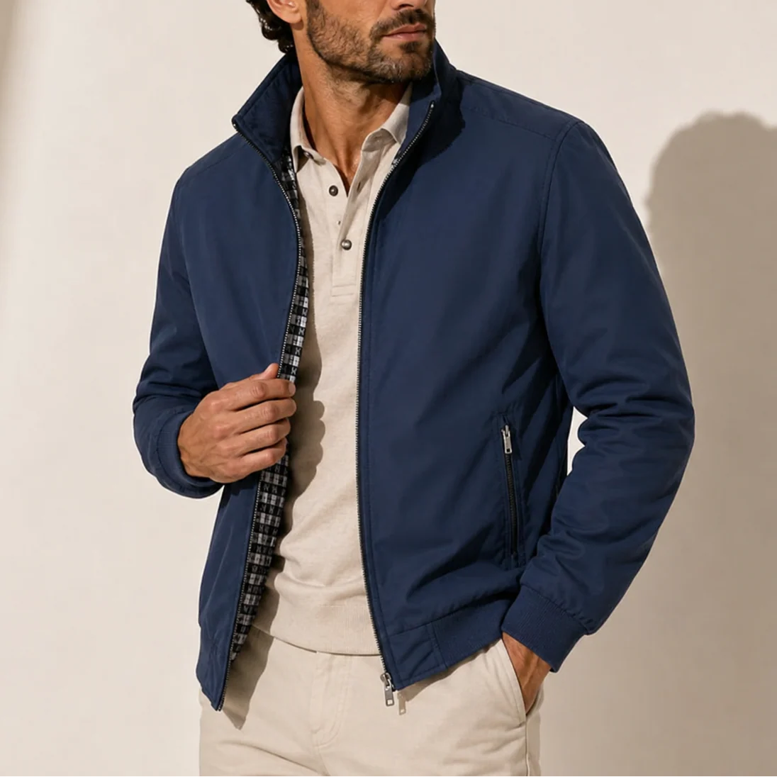 Detail shot of men's bomber jacket ribbed hem and zip closure construction