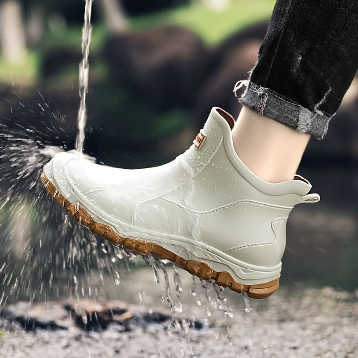 Men's slip-on ankle boots showing smooth synthetic upper and stitching detail