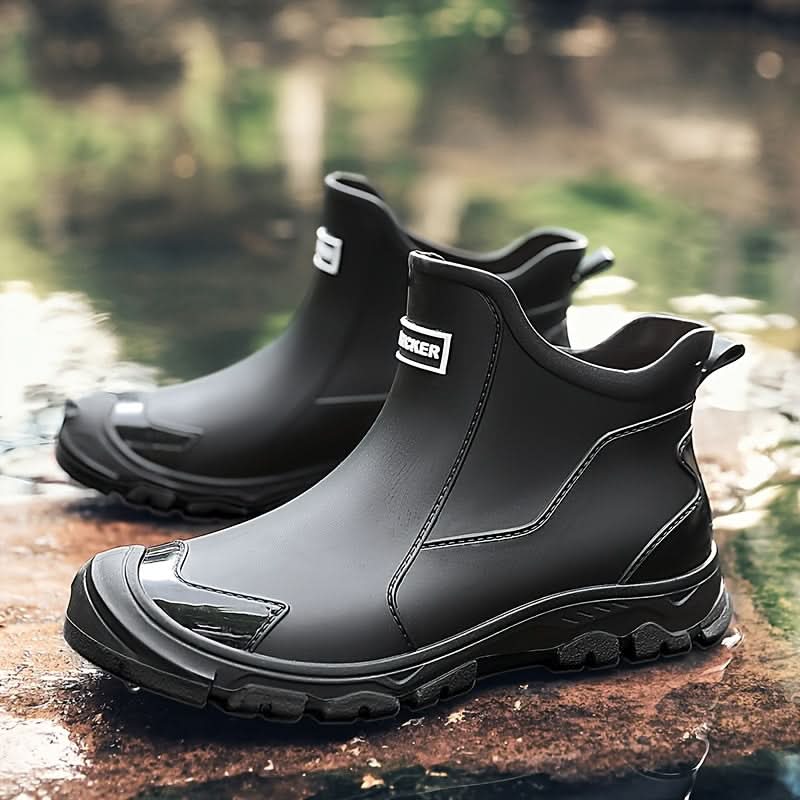 Men's Chelsea boots on stone surface highlighting chunky tread pattern