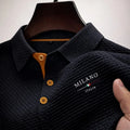 Men's textured polo shirt in charcoal with basketweave pattern, structured collar, and contrast button placket with embroidered chest detail