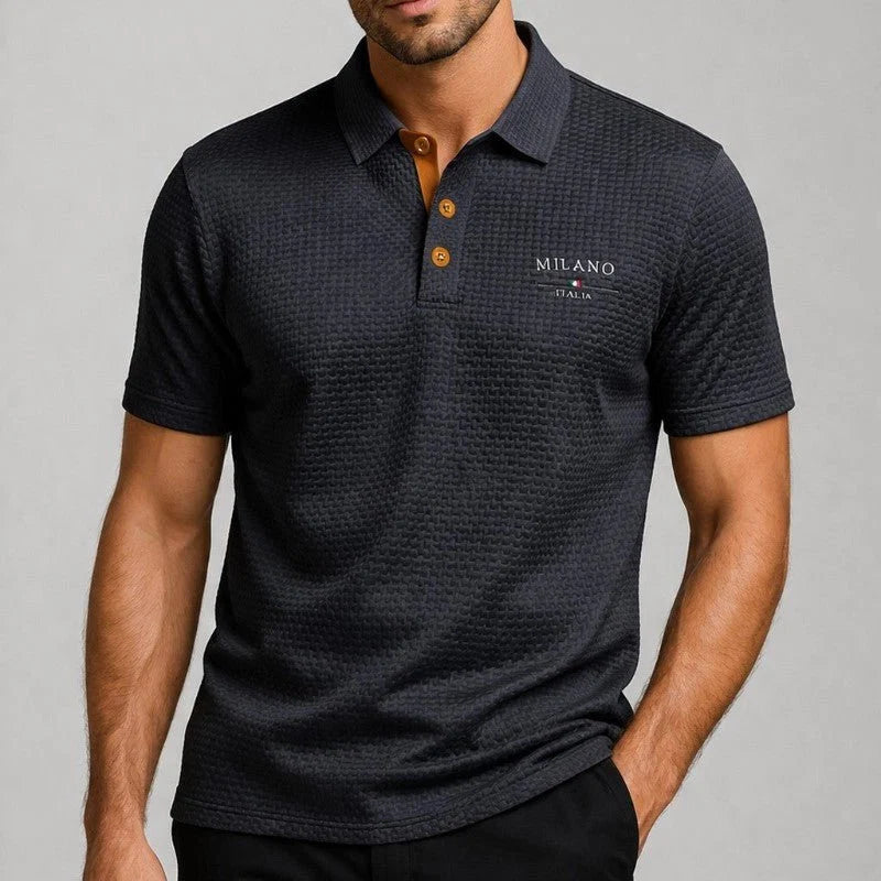 Men's textured polo shirt showing embroidered chest branding and basketweave pattern close-up