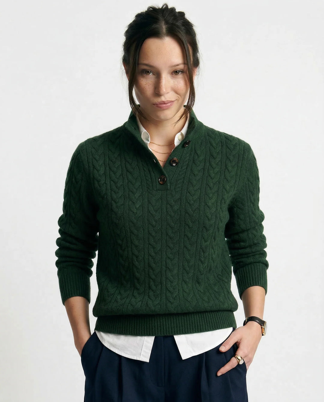Front view of women's cashmere cardigan in olive paired with neutral trousers