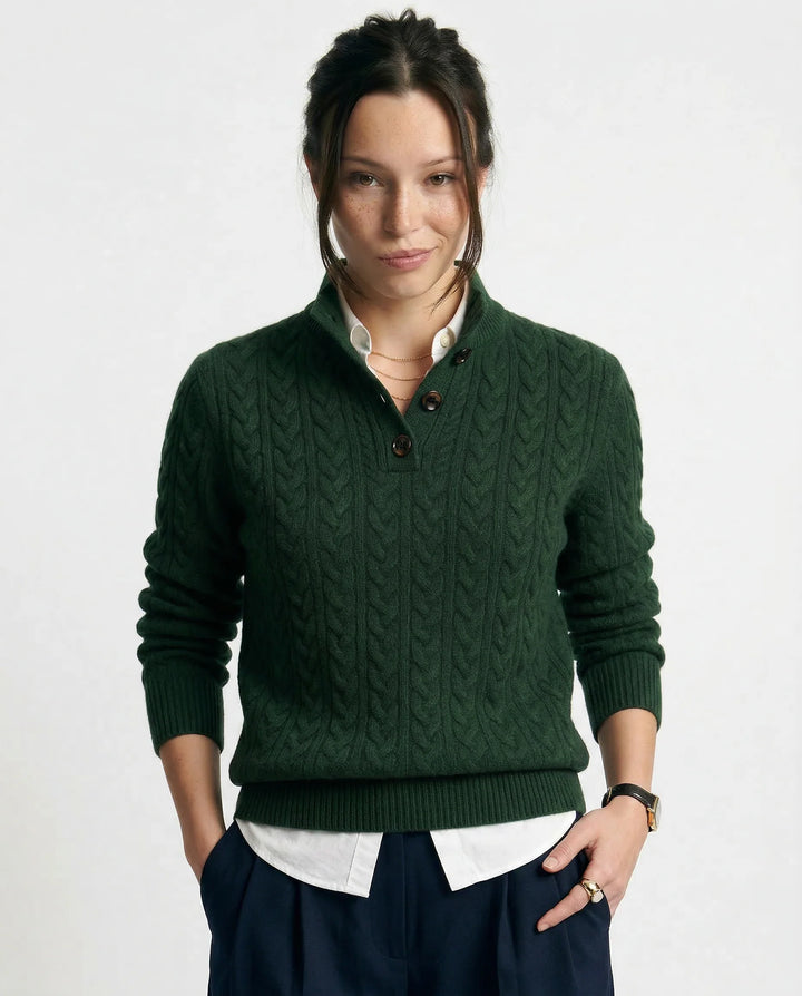 Front view of women's cashmere cardigan in olive paired with neutral trousers