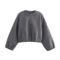 Women's cropped bomber jacket in grey with elasticated hem, cuffs and voluminous sleeves on white background