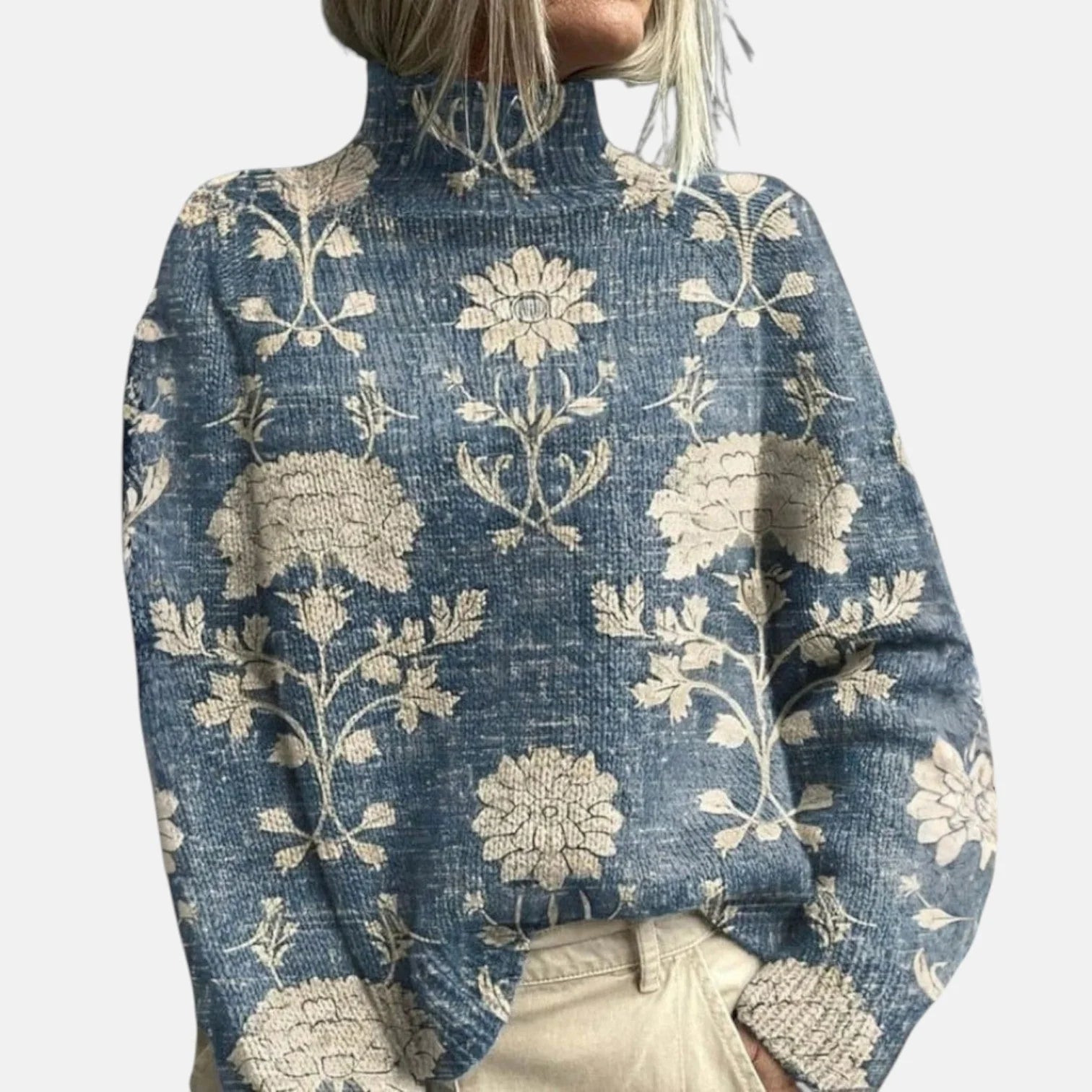 Relaxed fit ribbed knit turtleneck jumper with embroidered woodland design worn with neutral trousers