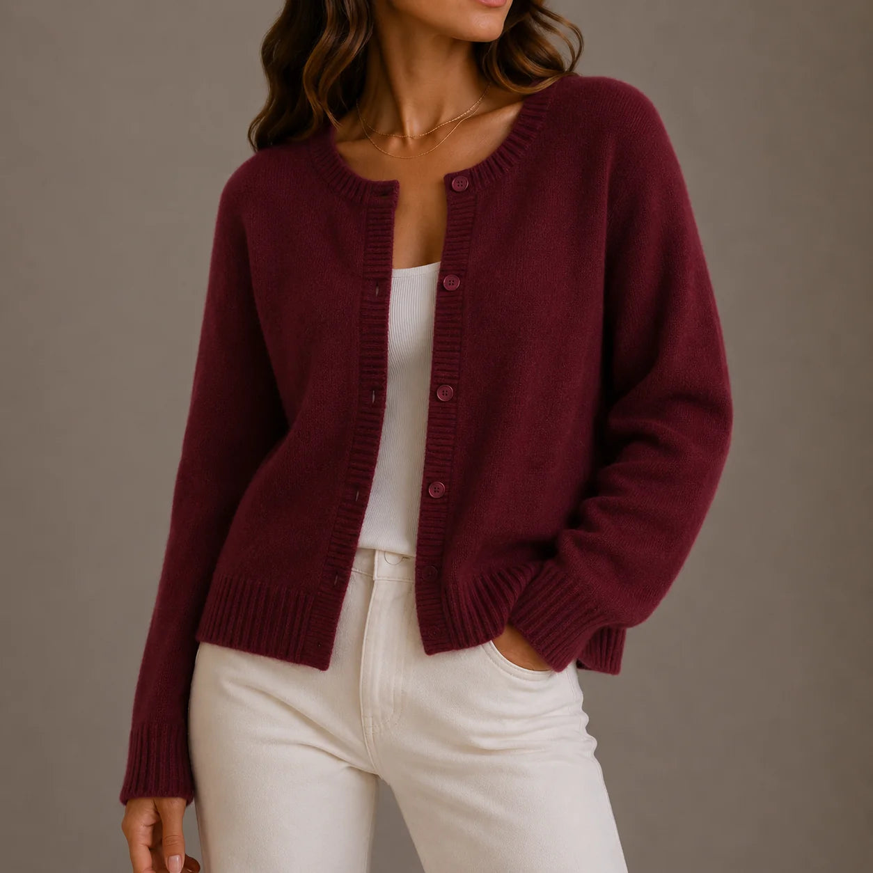Detail of women's knit cardigan cuff showing ribbed trim and long sleeve design