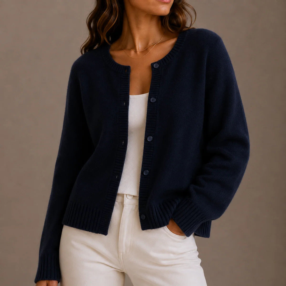 Women's classic cardigan in grey paired with cream trousers for effortless style