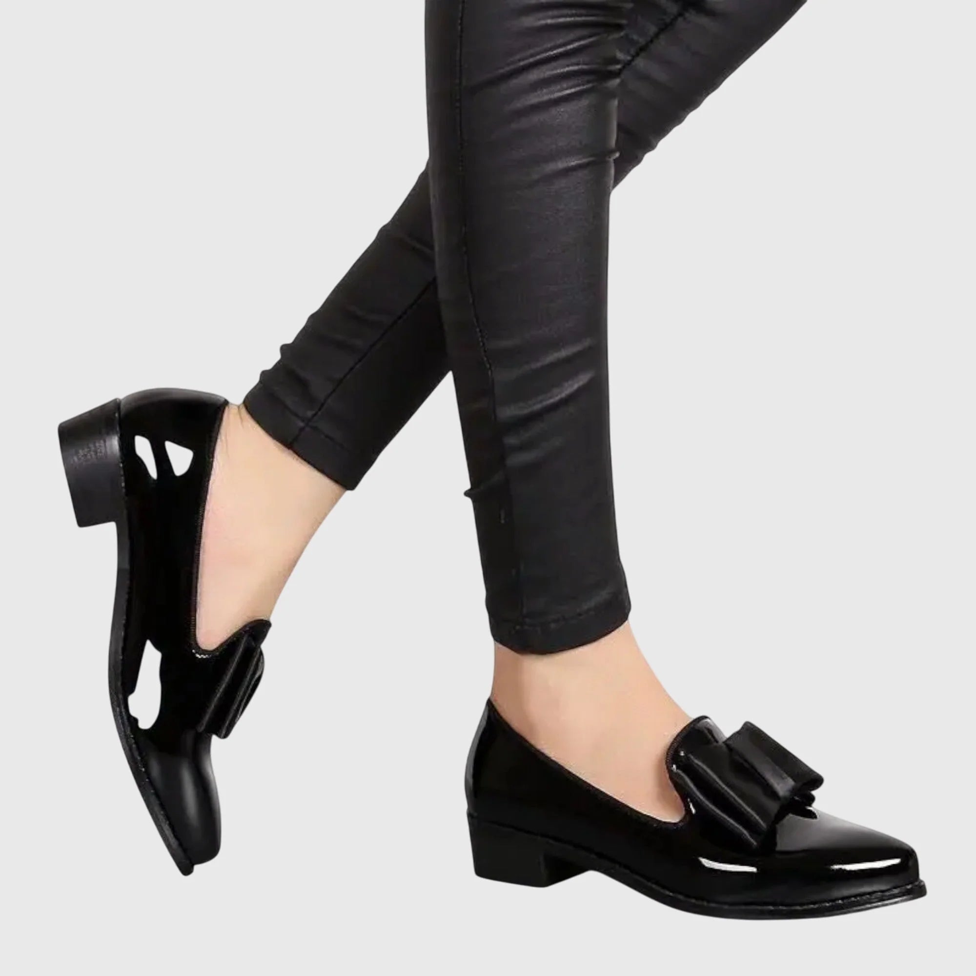 Full view of women's patent loafers showing slip-on construction and glossy surface finish
