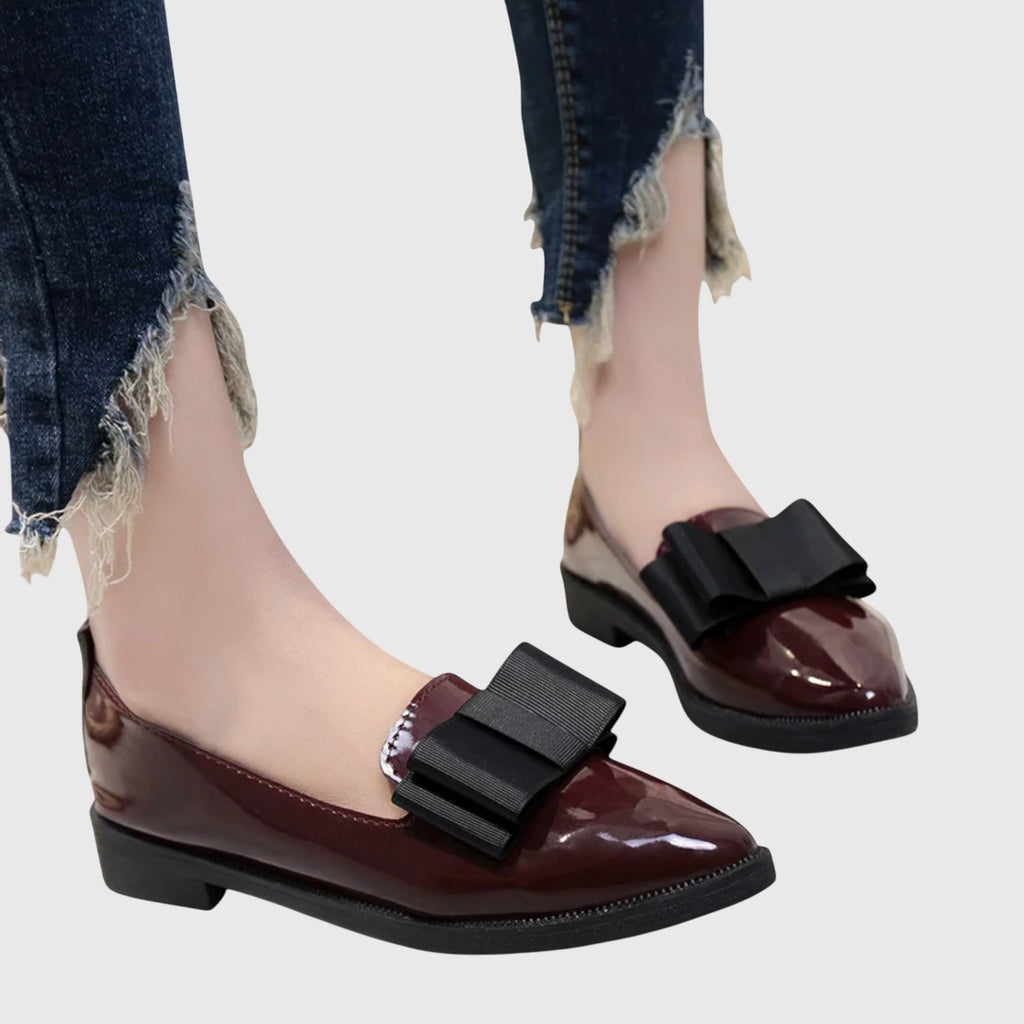 Women's patent loafers in black colourway with bow embellishment and slip-on design