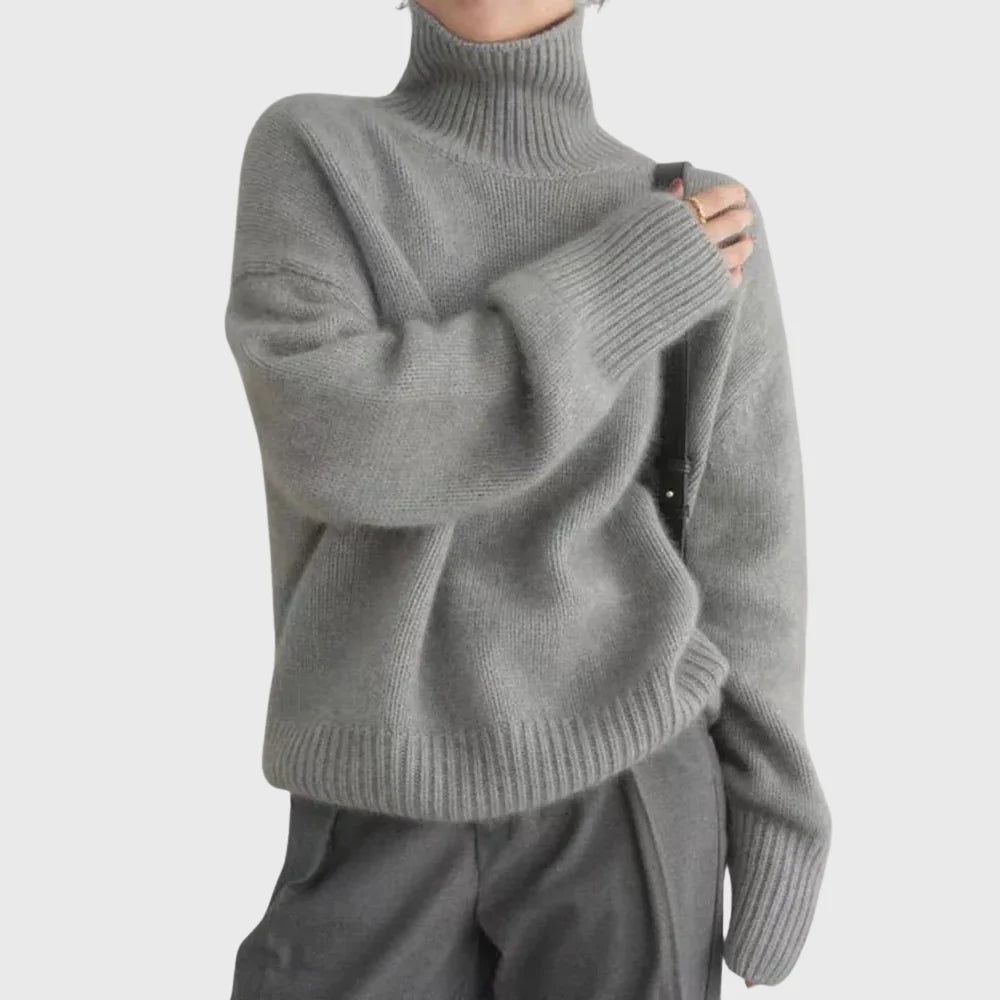 Side view of relaxed fit turtleneck jumper with drop shoulders and clean minimal silhouette